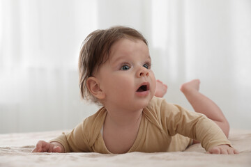 Fototapeta premium Portrait of cute little baby on bed indoors