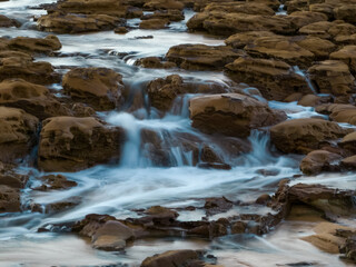 Sunrise and cascades over the rock platform