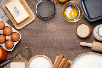 Flat lay composition with culinary utensils and ingredients on wooden table, space for text. yeast pastry