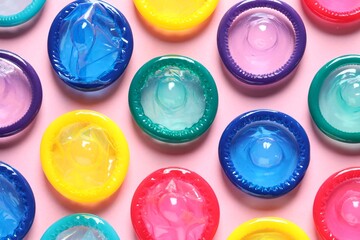 Colorful condoms on pink background, flat lay - obrazy, fototapety, plakaty