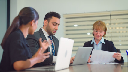 Obraz premium Group of diverse business people working together at modern office. They discuss business projects together.