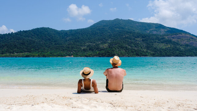 Couple on the beach of Koh Lipe Island Thailand, tropical Island with a blue ocean and white soft sand
