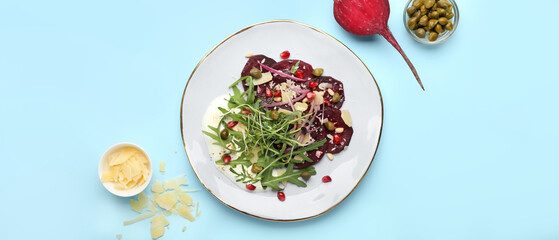 Plate with delicious beetroot carpaccio on light blue background