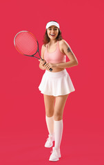 Fototapeta premium Young woman with tennis racket on pink background