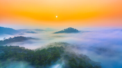Fototapeta na wymiar Aerial view of Xuan Tho suburbs near Da Lat city at morning with misty and sunrise sky. This place is considered most beautiful and peaceful place to watch sunrise in highlands of Vietnam