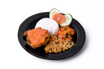 Rice with spicy fried chicken and vegetables on white background