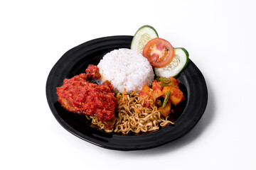 Rice with spicy fried chicken and vegetables on white background