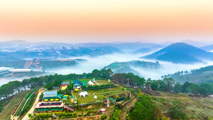 Aerial view of Xuan Tho suburbs near Da Lat city at morning with misty and sunrise sky. This place...