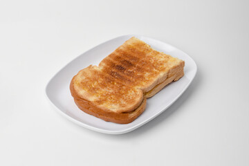 toasted bread on a white plate isolated on a white background.