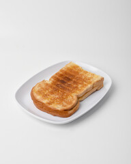 toasted bread on a white plate isolated on a white background.