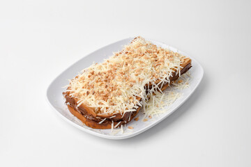 toasted bread topped with chocolate spread, cheese slices and nuts