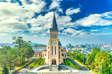 Fototapeta premium Aerial view outside Cathedral chicken in Da Lat, Vietnam on a morning. Old French architecture attracts parishioners to pray for peace at the weekend