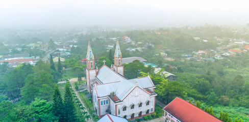 Tan Hoa parish church in Bao Loc, Vietnam on a foggy morning, a place for parishioners to come to confession and pray for peace for their families