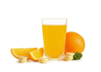 Glass of vitamin C effervescent tablet dissolved in water and oranges isolated on white background