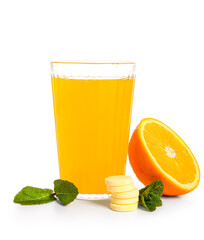 Glass of vitamin C effervescent tablet dissolved in water and orange isolated on white background