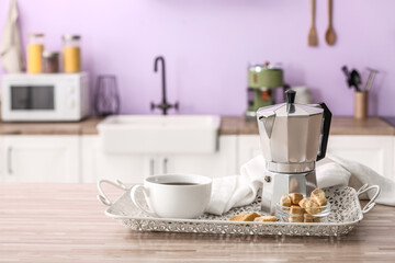 Fototapeta na wymiar Tray with geyser coffee maker, cup of espresso and snacks on wooden table in kitchen