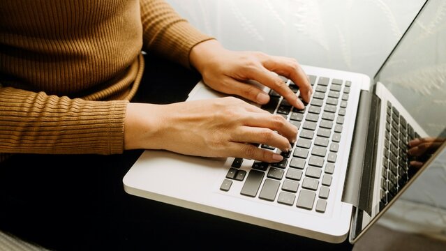 A female typing on a keyboard