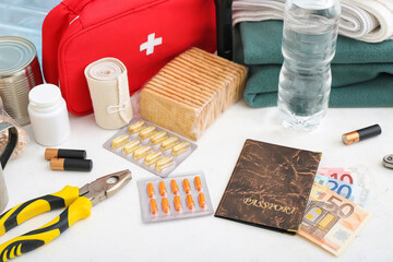 Necessities for emergency bag on white table, closeup
