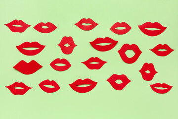 Red paper lips on green background