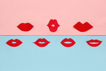 Red paper lips on color background