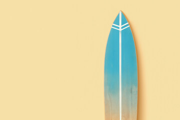 Wooden surfboard near beige wall, closeup