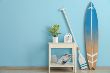 Interior of room with surfboard, paddle and table