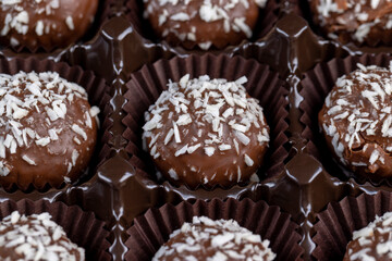 Chocolate candies in the form of balls with milk coconut