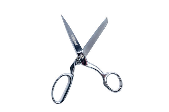 Open metal tailor scissors. Accessories and tools for hobbies and sewing profession. Close-up. Without background.