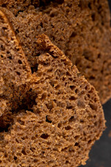 pieces of black rye bread from mixed wheat flour with rye flour