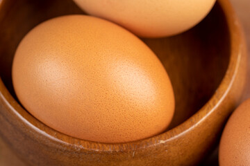 A clean whole orange chicken egg close-up on the table