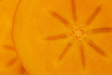 Half-ripe Orange persimmon, close up - obrazy, fototapety, plakaty