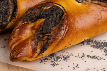 Fresh bun with poppy seed filling on the table