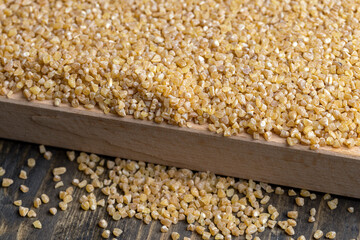 Fresh wheat porridge but cooked scattered on the table