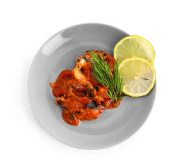 Plate with canned fish in tomato sauce isolated on white background