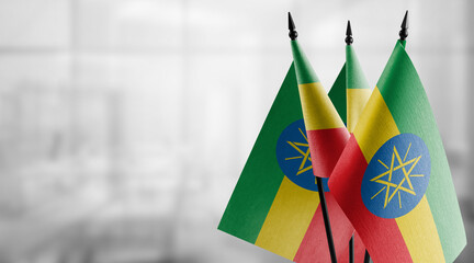 Small flags of the Ethiopia on an abstract blurry background