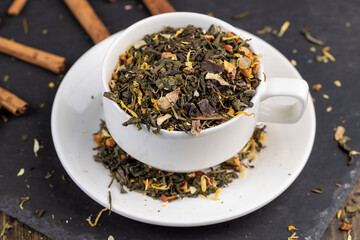 Dry green tea poured into a white mug