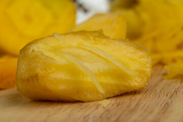 Sliced into thin slices of bright yellow carrots in the kitchen