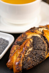 A large number of poppy seeds in a wheat bun