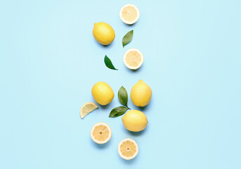 Composition with fresh lemons on blue background