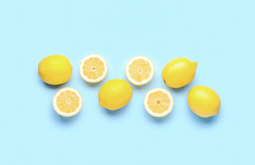 Composition with fresh lemons on blue background