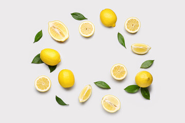 Frame made of fresh lemons on grey background