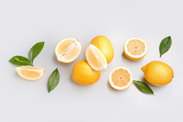 Composition with fresh lemons on grey background