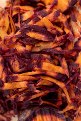 Finely grated red-orange carrots in the kitchen