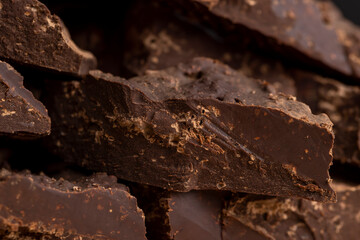 Pieces of chocolate with added cocoa and sugar