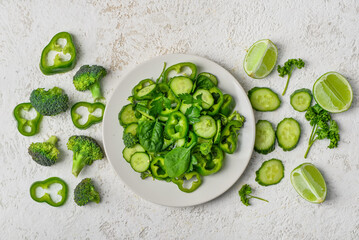 Plate of salad with green vegetables and ingredients on grunge background