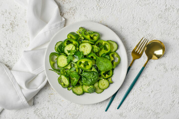 Plate of salad with green vegetables on grunge background