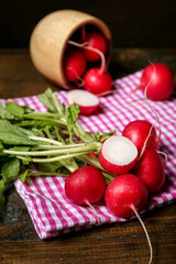 Bunch of ripe radish with green leaves on table