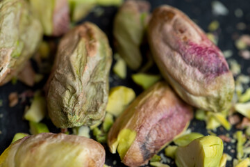 Scattered pistachios of green color with salty taste
