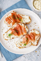 Plate of tasty bruschettas with jamon on light background