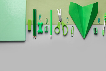 Composition with stationery supplies and paper plane on color background